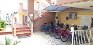 a row of bikes parked on the side of a building at Apartmenthotel Sithon in Sarti
