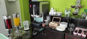 a kitchen with a counter with a coffee machine at Sonia Hotel & Suites in Kos Town