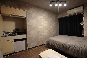 una piccola camera con letto e cucina di KB House Shinjuku Double room Free poket wifi! a Tokyo