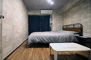 a bedroom with a bed and a table at KB House Shinjuku Double room Free wifi! in Tokyo