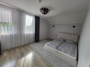 a bedroom with a bed and a large window at Lighthouse apartment in Nida