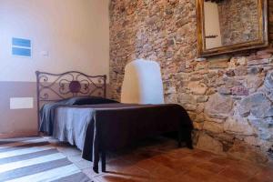Postel nebo postele na pokoji v ubytování Agriturismo Bio Fattoria di Pietra