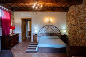 Postel nebo postele na pokoji v ubytování Agriturismo Bio Fattoria di Pietra