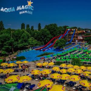 a group of yellow umbrellas and a water park at DelSool Mamaia in Mamaia