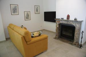 a living room with a couch and a fireplace at Il Sottolo in Florence