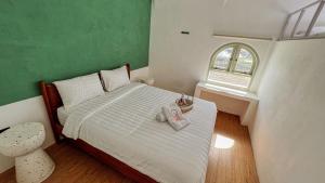 Ein Bett oder Betten in einem Zimmer der Unterkunft Renjana Beach House