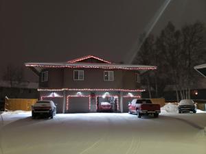 a house decorated with christmas lights in a driveway at Beautiful 2 bedroom 1 bath apartment with private garage in Anchorage