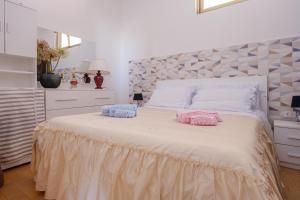 a bedroom with a bed with two pillows on it at Casa tra cielo e mare in Salento in San Foca