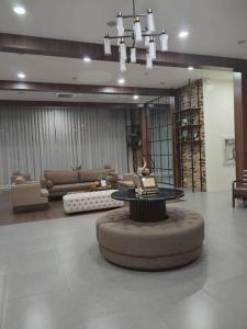 a lobby with a table in the middle of a room at ZackG Serene Homestay at Brenthill 210 Baguio in Baguio