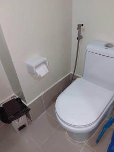 a bathroom with a white toilet in a room at ZackG Serene Homestay at Brenthill 210 Baguio in Baguio