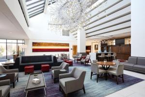 a lobby with couches and tables and a chandelier at Hanover Marriott in Whippany