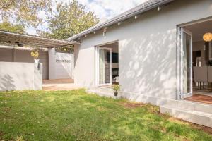 una casa blanca con patio en 74 on 19th, en Johannesburgo