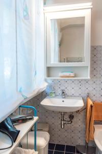 een badkamer met een wastafel, een spiegel en een toilet bij M261 - Marcelli, trilocale ristrutturato con terrazzo vista mare pt in Marcelli