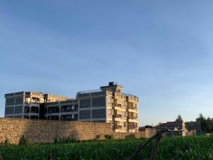 a building in front of a brick wall at Rorot Spacious one bedroom in Kapsoya with free Wifi in Eldoret