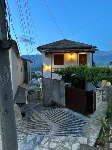 a house with a pathway leading up to it at Jons Apartment in Gjirokastër