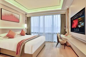 a hotel room with a bed and a large window at SSAW Boutique Hotel Yingyang in Hangzhou