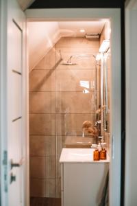 a bathroom with a sink and a shower at Poddasze dla Znajomych - apartament z gorącą balią in Kluszkowce