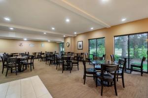 una sala da pranzo con tavoli, sedie e finestre di Best Western Plus Plaza by the Green a Kent