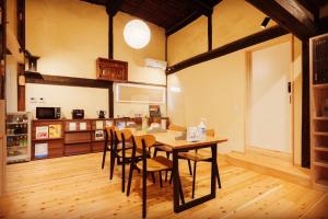 a kitchen and dining room with a table and chairs at FARMSTAY miyuki-street "Goen" in Ukiha