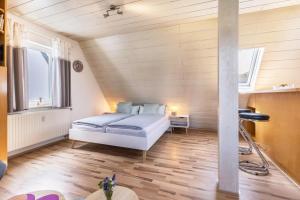 a bedroom with a bed in a room with wooden floors at Apartment Allerliebst in Albstadt