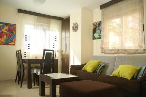 a living room with a couch and a table at 1ra Linea Playa Magic World Luxury Apartament PP3 Pet in Oropesa del Mar