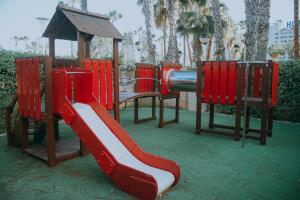 a playground with a red slide and a gazebo at 1ra Linea Playa Magic World Luxury Apartament PP3 Pet in Oropesa del Mar