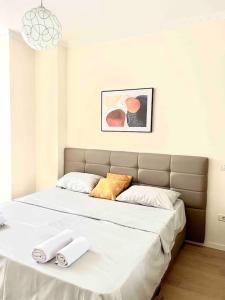 a bedroom with a large bed with two towels on it at Peaceful Condo in City Center in Durrës