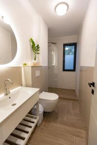 a bathroom with a toilet and a sink at DelSool Mamaia in Mamaia