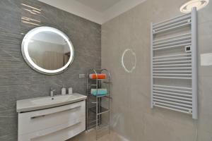 a bathroom with a sink and a mirror at Apartments Mala Vala 925 - adapted in Fažana
