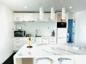 a kitchen with white cabinets and a white counter top at Amber Hill B in Buckland