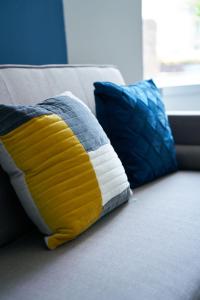 two pillows are sitting on a couch at Meadow Apartment in Dumbarton
