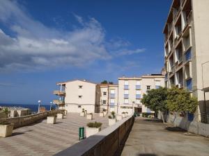 une rue de la ville avec des bâtiments et un ciel bleu dans l'établissement la perle de bougie, à Béjaïa