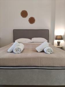 a bedroom with a bed with two pillows on it at Galini Rooms & Apartments in Finikas