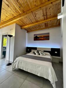 Schlafzimmer mit einem Bett mit Holzdecke in der Unterkunft Dimora Schiappone in Ischia