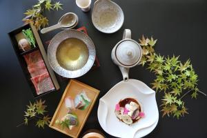 a table with a plate of food and a bowl of soup at SEKIYA RESORT Bettei Haruki in Beppu +37 photos