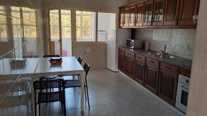 a kitchen with a counter and a table and chairs at Terra e Mar in Amorosa