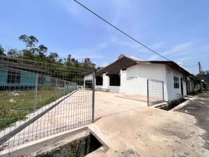 uma cerca em frente a um edifício branco em HOMESTAY TOK ABAH em Kuala Berang