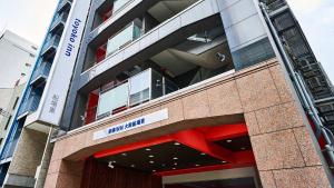 a building with a sign on the side of it at Toyoko Inn Osaka Semba Higashi in Osaka