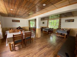 a restaurant with tables and chairs and a person sitting at a table at Zaltak Guest House and Hostel in Leh +26 photos