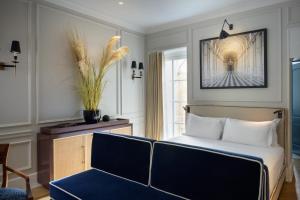 a bedroom with a bed and a chair and a window at Casa Violante Luxury Apartment in Rome