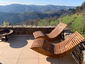 a wooden bench sitting on a patio with a table at Les chambres de la Bastide in Saint-Sauveur-de-Montagut