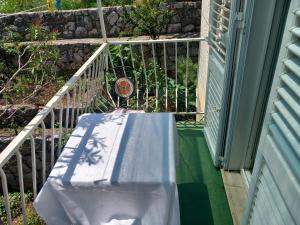 a table sitting on the porch of a house at Guest House Mrdalo in Dubrovnik