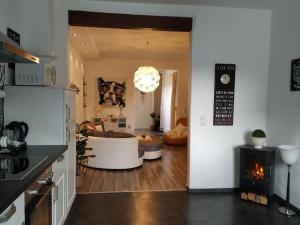a kitchen and living room with a dog poster on the wall at Ferienwohnung Waldblick in Trier