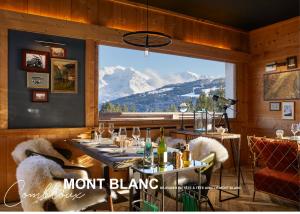 a dining room with a view of a mountain at Chalet Alpen Valley, Mont-Blanc in Combloux
