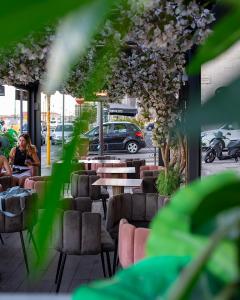 a group of tables and chairs on a sidewalk at Aroma Apartment, Maschio Angioino-Porto Di Napoli in Naples