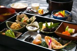 a tray filled with different types of food on a table at Bettei Haruki in Beppu