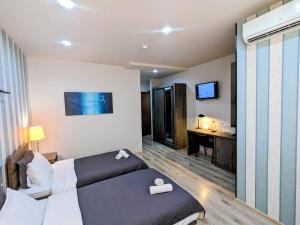 a hotel room with a bed and a desk at Sani Hotel in Tbilisi City