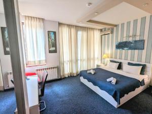a bedroom with a large bed with two towels on it at Sani Hotel in Tbilisi City