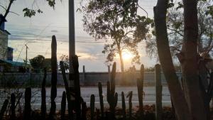 a fence with a sunset in the background at Ban Bang Home Resort in Haad Chao Samran