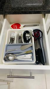 a drawer filled with utensils in a cabinet at La Lucia Sleepover in Durban